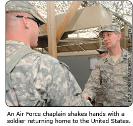 An Air Force chaplain shakes hands with a soldier returning home to the United States.