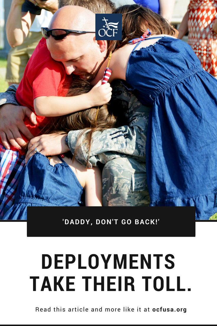 Military dad hugs his children.