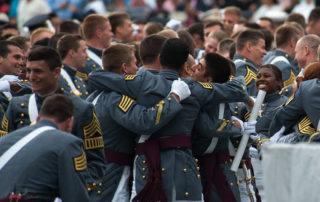 West Point Cadets hug at the completion of the 2014 graduation and commissioning ceremony at the United States Military Academy, West Point, N.Y., May 28, 2014. (U.S. Army photo by Sgt. Mikki L. Sprenkle/Released)